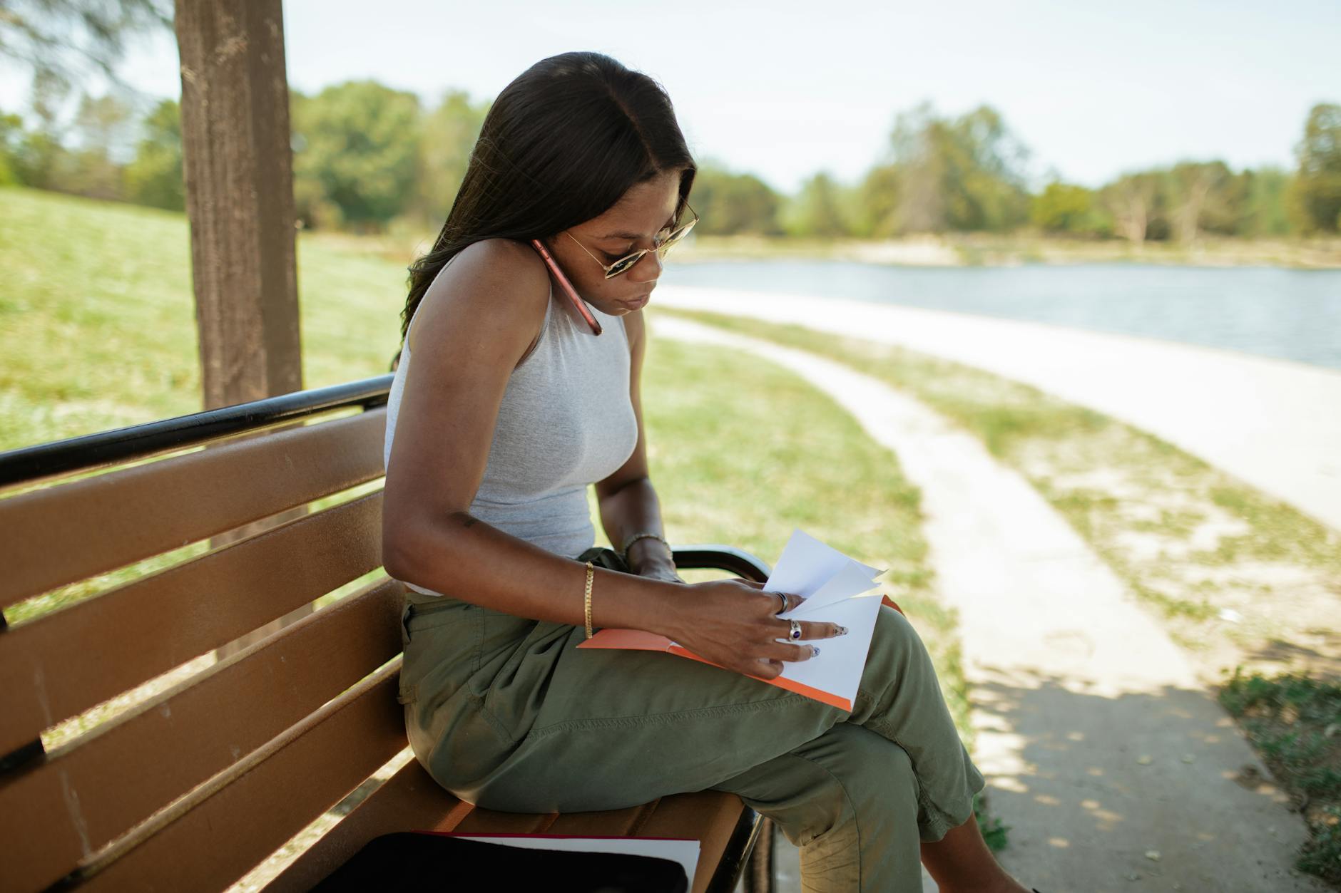 woman checking documents while talking on the phone